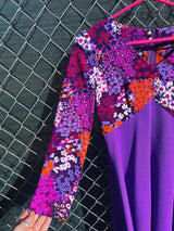 Women's vintage 1970's long sleeve maxi length dress in purple and multicolored floral print in polyester material.