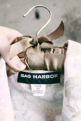 Women's vintage 1980's Sag Harbor label long sleeve lightweight floral print blazer with one gold button closure. White with pink and blue flowers.