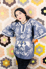 Women's vintage 1970's blue chambray tunic blouse with flared sleeves and a V shaped neckline. Has a white embroidered bird on the front.