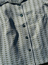 Women's vintage 1970's long sleeve button up shirt blouse in green and white printed polyester material.