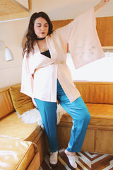 Women's vintage 1960's traditional kimono robe jacket in a pale pink color. Silk material with floral embroidery throughout.