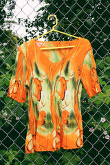 Women's vintage Y2k short sleeve bright orange tightly pleated scrunchy blouse top with a green abstract print.