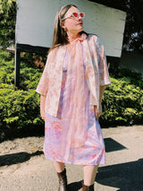 Women's vintage 1980's sleeveless midi length nightie dress in light purple, pink, and peach all over tie dye print. Has lace trim.