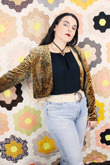 Women's vintage 1990's High Drama label long sleeve cropped fit open front velvet top with an all over black and gold snakeskin print.