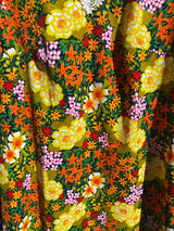 Women's vintage 1970's short sleeve mini length multicolored floral printed dress in polyester with lace trim collar.