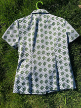 Women's vintage 1970's short sleeve button up shirt blouse in green and white print in polyester material.