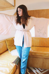 Women's vintage 1960's traditional kimono robe jacket in a pale pink color. Silk material with floral embroidery throughout.