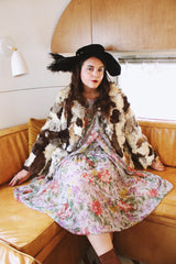 Women's vintage 1970's long sleeve multicolored patchwork genuine fur coat with hook and eye closures in the front. Grey, brown, cream, and black colors