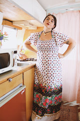 Women's vintage 1970's maxi length dress with flutter sleeves in white. Has an all over red and black ditsy floral print.