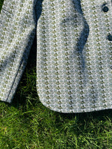 Women's vintage 1970's long sleeve button up shirt blouse in green and white printed polyester material.