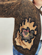 Women's vintage 1980's long sleeve brown orange wool cardigan with brass buttons and two abstract patches in the front.