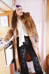 Women's vintage 1960's Apropos, Made in Korea label long sleeve knee length genuine fur coat with burnt orange leather trim and a tie belt.