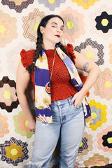 Women's vintage burnt orange acrylic crochet sweater top. Sleeveless with ruffles trim on shoulders. Has a short fit.