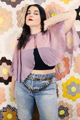 Women's vintage 1980's sheer silk material cape blouse in a light purple color. Has one hook and eye closure at neck with attached bow.