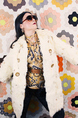 Women's vintage 1960's long sleeve genuine fur pea coat with a double breasted closure. Cream colored with all over brown speckles.