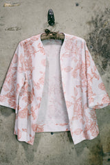 Women's vintage 1970's open front silver metallic blouse with short sleeves and all over white and pink rose floral print.