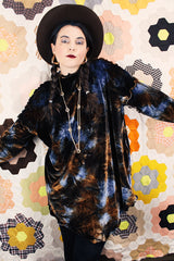 Long sleeve long length tie dye velvet top with a mock neck in a stretchy velvet material. Blue and brown colors with curly trim throughout.