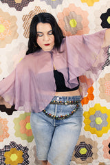 Women's vintage 1980's sheer silk material cape blouse in a light purple color. Has one hook and eye closure at neck with attached bow.