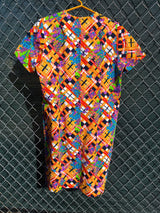 Women's vintage 1970's short sleeve mini length multicolored shift dress in polyester with v shaped neckline.