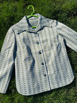 Women's vintage 1970's long sleeve button up shirt blouse in green and white printed polyester material.