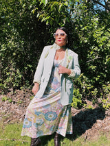 Women's vintage 1970's sleeveless ankle length maxi dress. Nightgown loungewear style with an all over pink, green, and blue pastel colored print.