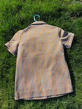 Women's vintage 1970's short sleeve button up shirt blouse in brown and white checkered print polyester material.