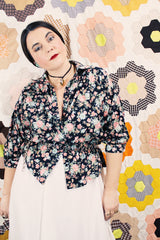 Women's vintage 1970's Ship N' Shore label short sleeve all over ditsy floral print blouse that buttons up the front and cinches at the waist.