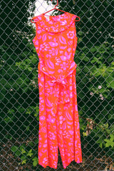 Women's vintage 1970's Liberty House for Lila Honolulu label sleeveless ankle length jumpsuit in a vibrant pink and orange Hawaiian print.