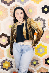 Women's vintage 1990's High Drama label long sleeve cropped fit open front velvet top with an all over black and gold snakeskin print.