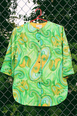 Women's vintage 1970's Alex Colman California label 3/4 arm length button up smock blouse in a vibrant green abstract print. Brass buttons and side slits.