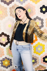 Women's vintage 1990's High Drama label long sleeve cropped fit open front velvet top with an all over black and gold snakeskin print.