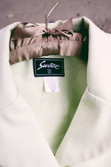 Women's vintage 1990's Sweet Suit label short sleeve button up blazer with double lapel and silver metal detail. In a light green and white all over checkered print.