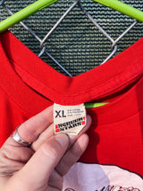 Women's or men's vintage 1970's Screen Stars, Made in the USA label short sleeve red graphic t-shirt with Yasgur's Farm logo which is the farm where Woodstock took place.