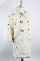 Women's vintage 1960's long sleeve genuine fur pea coat with a double breasted closure. Cream colored with all over brown speckles.