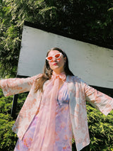 Women's vintage 1970's open front silver metallic blouse with short sleeves and all over white and pink rose floral print.