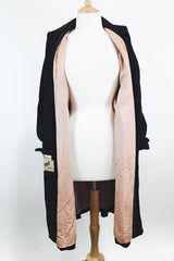 Women's vintage 1950's "365" by All-State label long sleeve knee length black velvet duster jacket with button front closure and pink satin liner.