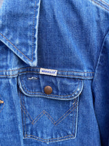 Women's vintage 1970's Wrangler, Made in USA long sleeve button up medium wash denim jacket with brass hardware and pockets.