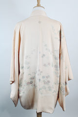 Women's vintage 1960's traditional kimono robe jacket in a pale pink color. Silk material with floral embroidery throughout.