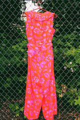 Women's vintage 1970's Liberty House for Lila Honolulu label sleeveless ankle length jumpsuit in a vibrant pink and orange Hawaiian print.