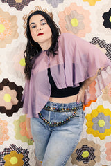 Women's vintage 1980's sheer silk material cape blouse in a light purple color. Has one hook and eye closure at neck with attached bow.