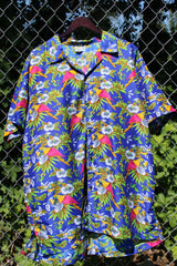 Men's vintage 1990's Island Shirtworks label short sleeve button up Hawaiian print shirt in blue with all over parrot print in a lightweight Polyester material.