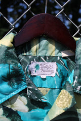 Men's vintage 1970's Waikiki Holiday label short sleeve button up Hawaiian print shirt with two chest pockets. Green and blue camera print in polyester material.