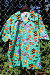 Men's vintage 1980's CPR ZIN, USA label short sleeve button up Hawaiian print shirt in turquoise with an all over fish print in a cotton material.