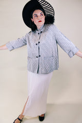 Women's vintage 1960's The Original Stork-A-Lure label long sleeve grey stain jacket with all over print. Black buttons up the front and mandarin collar.