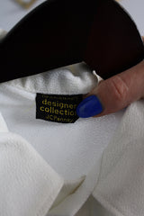 Men's or women's vintage 1970's Towncraft Designer Collection JCPenney label short sleeve white polo top with collar and half button closure in lightweight polyester.