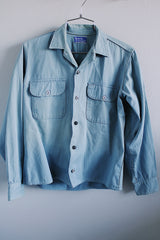 Men's or women's vintage 1970's Woodward's 7 Star Workwear label button up light blue chambray cotton shirt with two chest pockets.