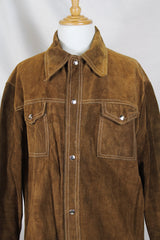 Men's or women's vintage 1970's long sleeve light brown tan colored suede jacket. Has silver snap buttons, contrast stitching, and a dagger collar.