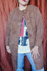 Women's vintage 1960's long length long sleeve tan brown colored suede jacket. No collar and suede buttons up the front.
