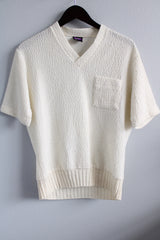 Women's or men's vintage 1970's Joel, Cal Made label short sleeve white top with a V shaped neckline and a chest pocket in textured acrylic material.