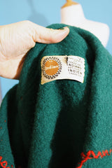 Women's vintage 1970's Indian, Handcrafted by Canadian Indians label long sleeve forest green pullover sweater with a collar and tie front.